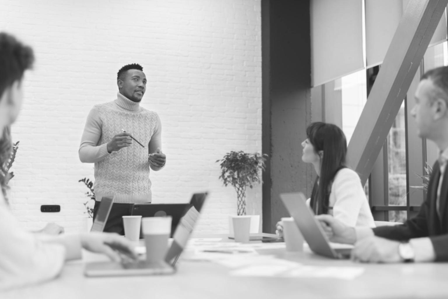 Business meeting with financial charts and statistical analysis displayed on screens