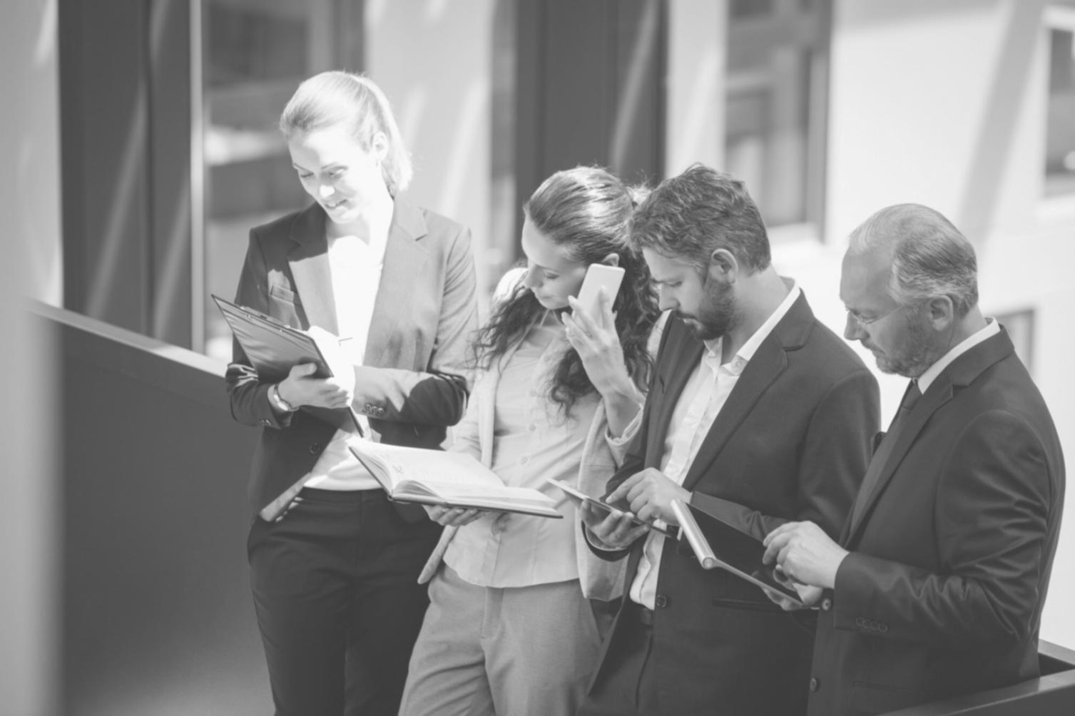 Collaborative financial planning meeting showing team members working together on scenario modeling and strategic analysis